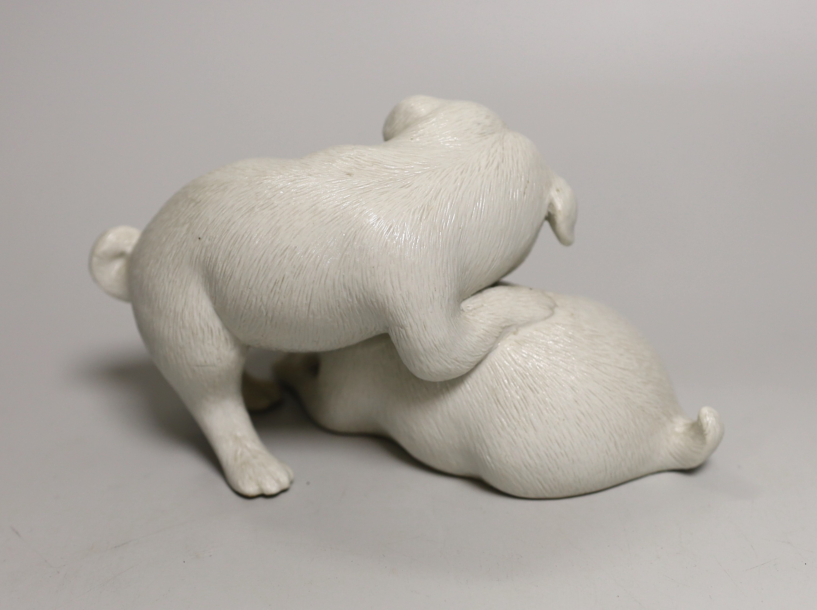 A Japanese Hirado white glazed model of two pugs, Meiji period, 17cm
